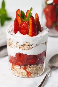 Strawberry breakfast with oat in a jar on white background..