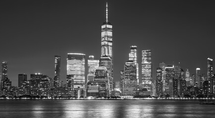 Black and white picture of Manhattan skyline at night, New York City, USA.