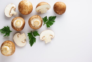 Mushrooms with parsley leaves on a white background, flatlay