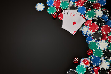 Casino chips, playing cards and dices on dark reflective background