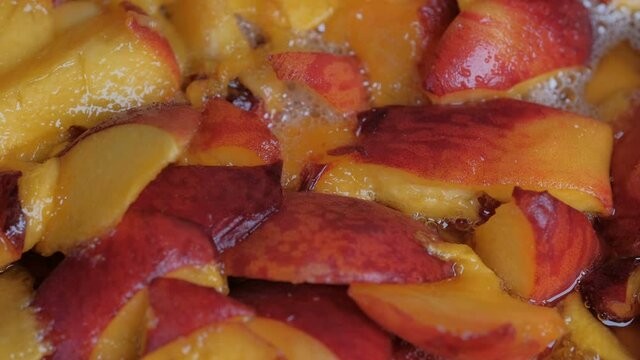 Making jam from ripe juicy sweet peach fruits close-up macro photography top view