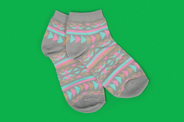 Pair of gray socks on colored background