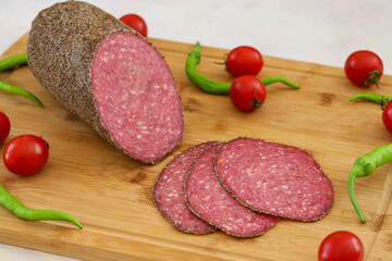 Italian salami on wooden background. beef salami