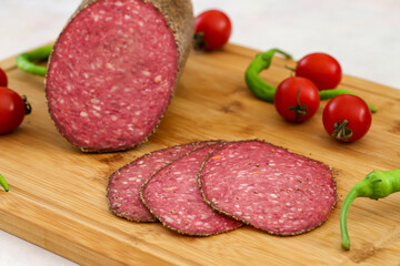 Italian salami on wooden background. beef salami