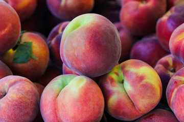 close-up ripe peaches on the market stall