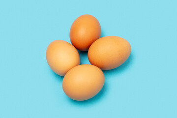 Four chicken eggs on a colorfull background