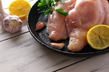 Chicken meat with lemon and garlic in a frying pan, Cooking by the chef