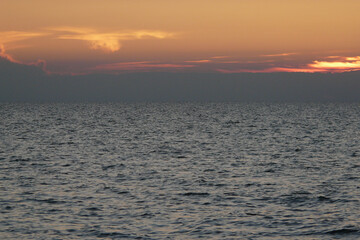 Calm Sea of Azov at sunset. Sunset sky over the sea