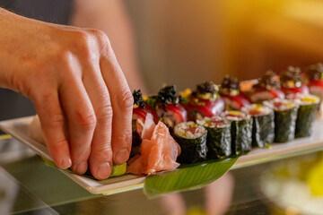 Chef decorating sushi rolls