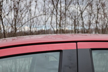 Hail damage at car, red colored car