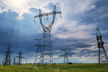 High-voltage electric lines, towers and industrial infrastructure against the blue sky