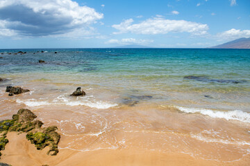 Beach with golden sand, turquoise ocean water. Panoramic sea view. Natural background for summer vacation.