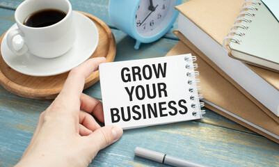 Grow your small business. Woman holding a card with a message text written on it