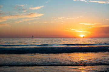 Sunrise over the sea and beautiful cloudscape. Colorful ocean beach sunset.