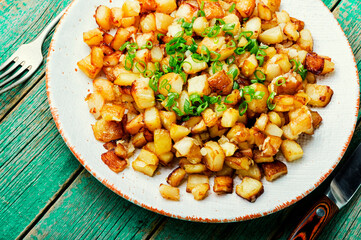 Fried potatoes with green onions