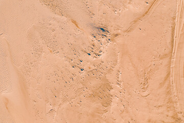 Wind wave vortices in sand background from aerial top view, beach texture