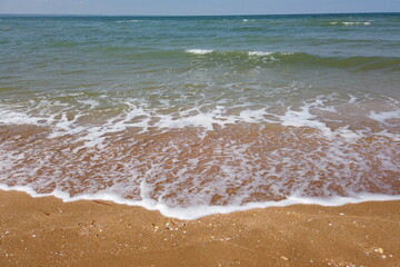Wave of the sea on the sand beach