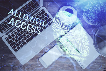 Finger print over computer on the desktop background. Top view. Double exposure. Concept of securitization.