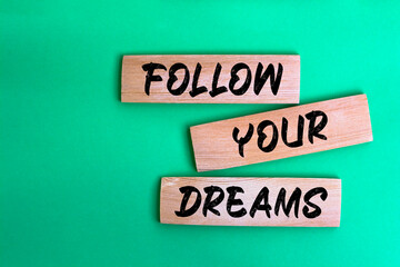 Follow your dreams word written on wood block. Follow your dreams text on wooden table for your design, Top view concept