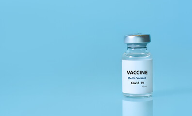 Bottle of Covid-19 vaccine to immunize from the Delta Variant Coronavirus on blue background. The...