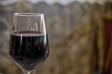 Alentejo red wine glass with the stone background.