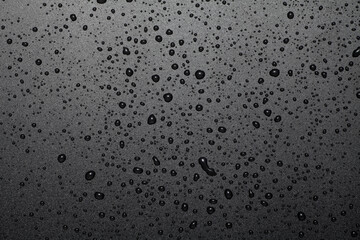 Water drops on black plastic material background