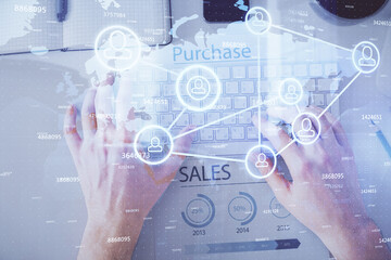 Double exposure of man's hands typing over computer keyboard and social network theme hologram drawing. Top view. People connection web concept.