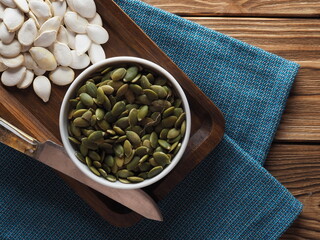 Pumpkin seeds on a wooden board, a useful product
