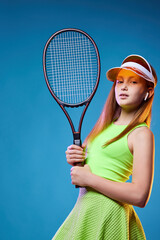 girl teenager with racket in sporswear and hat