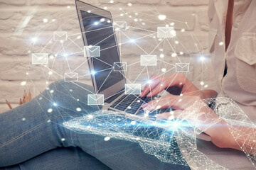 Double exposure of woman hands typing on computer and flying envelop drawing. E-Mail concept.