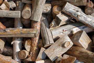 Firewood texture logs rural scene brown background. Pile of wood logs ready for winter. A pile of chopped firewood ready for stacking. High quality photo
