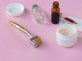 Mezoroller, dermaroller, mesotherapy skin tool. pink background. Roller set with microscopic needles. Stimulate collage. beauty pain concept.n production. High quality photo