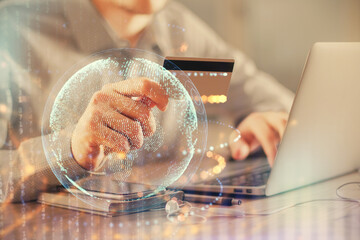 Double exposure of man hands holding a credit card and world map drawing. International Internet E-commerce and technology concept.