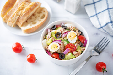 Canned Tuna red onion egg cucumber salad in a bowl