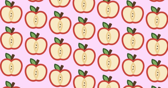 Composition of red apple halves repeated in rows on pale pink background