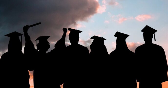Composition of silhouettes of graduated students in caps and gowns against sunset sky