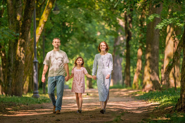 Fototapeta premium Portrait of a happy traditional family on walk in a summer park