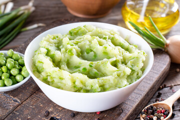 Mashed green peas and potatoes in a bowl on a table