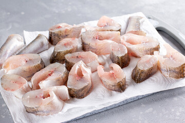 Frozen fish on a cutting board on a table. Frozen food