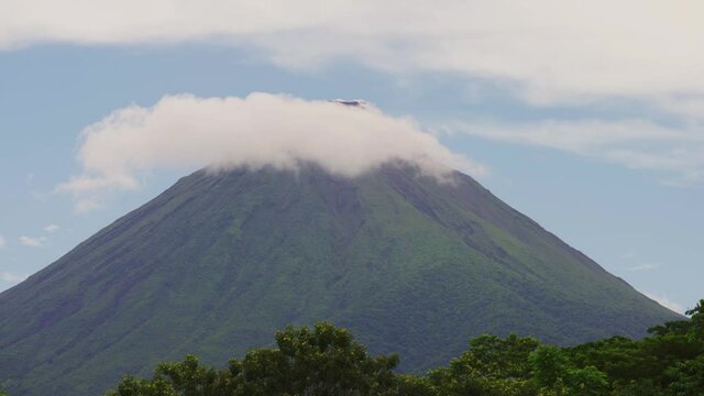 Arenal Volcano active andesitic stratovolcano With the movement of clouds around the summit
