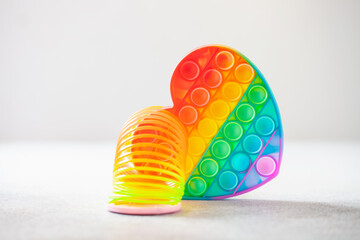 Multicolor children's toy spring rainbow spiral and pop it. Hipster anti stress toys