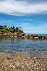 Italian rocky beach with small harbour and big villa. Holiday in Italy in summertime, seascape travel destination
