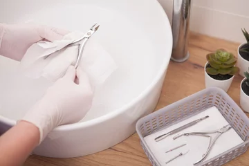 Wanddecoratie Nagelstudio Close up of manicurist drying instruments after washing  © Ihor
