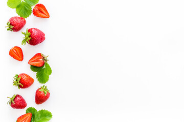 Red ripe strawberries with green leaves. Top view