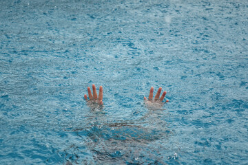 girl's hand drowning in the rain 