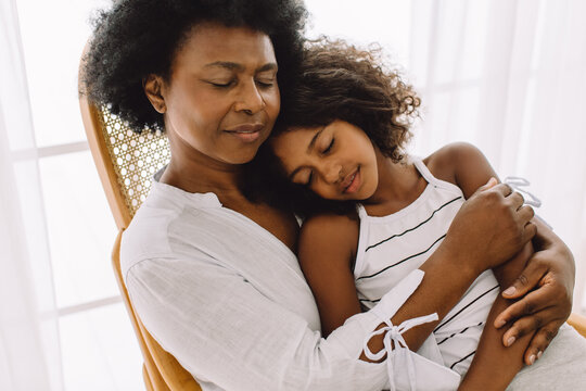 Mature Woman With Girl Sleeping In Chair