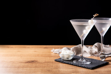 Gibson martini cocktail with onions on wooden table. Copy space