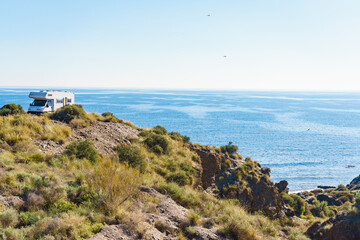 Camper on cliff, coast in Spain