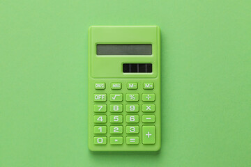 Green Calculator on Green background - obrazy, fototapety, plakaty