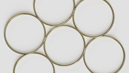 Gold torus shapes lying on the white background, top view, point of view, copy space, circular design elements, 3D render visualisation, golden circles